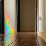 suncatchers cast rainbow on hall way