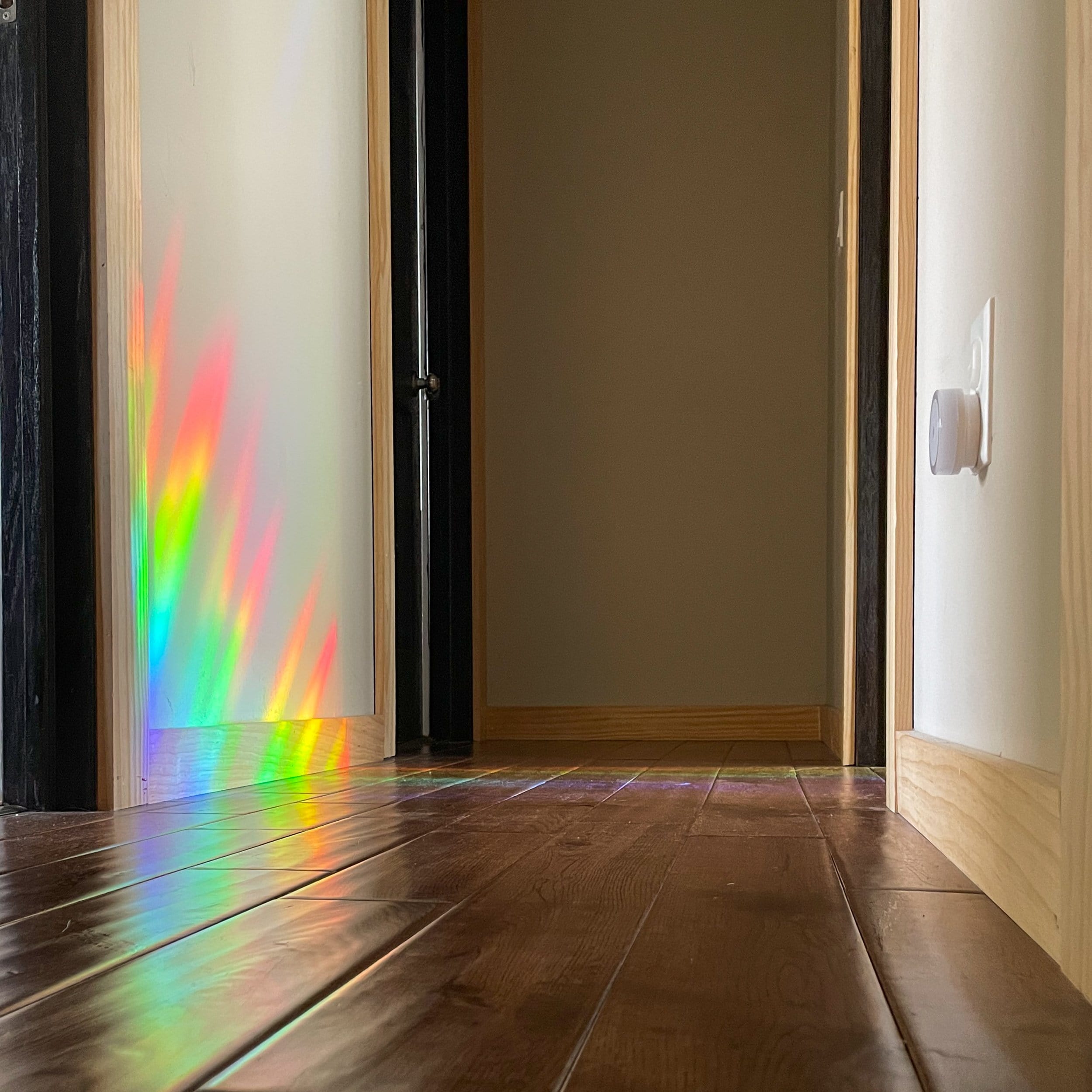 suncatchers cast rainbow on hall way